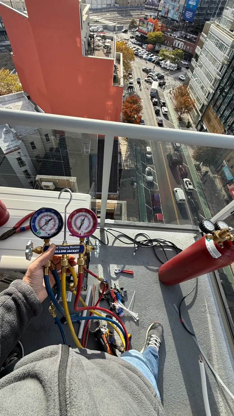Commissioning a mini-split system with manifold gauges on a high-rise balcony in New York