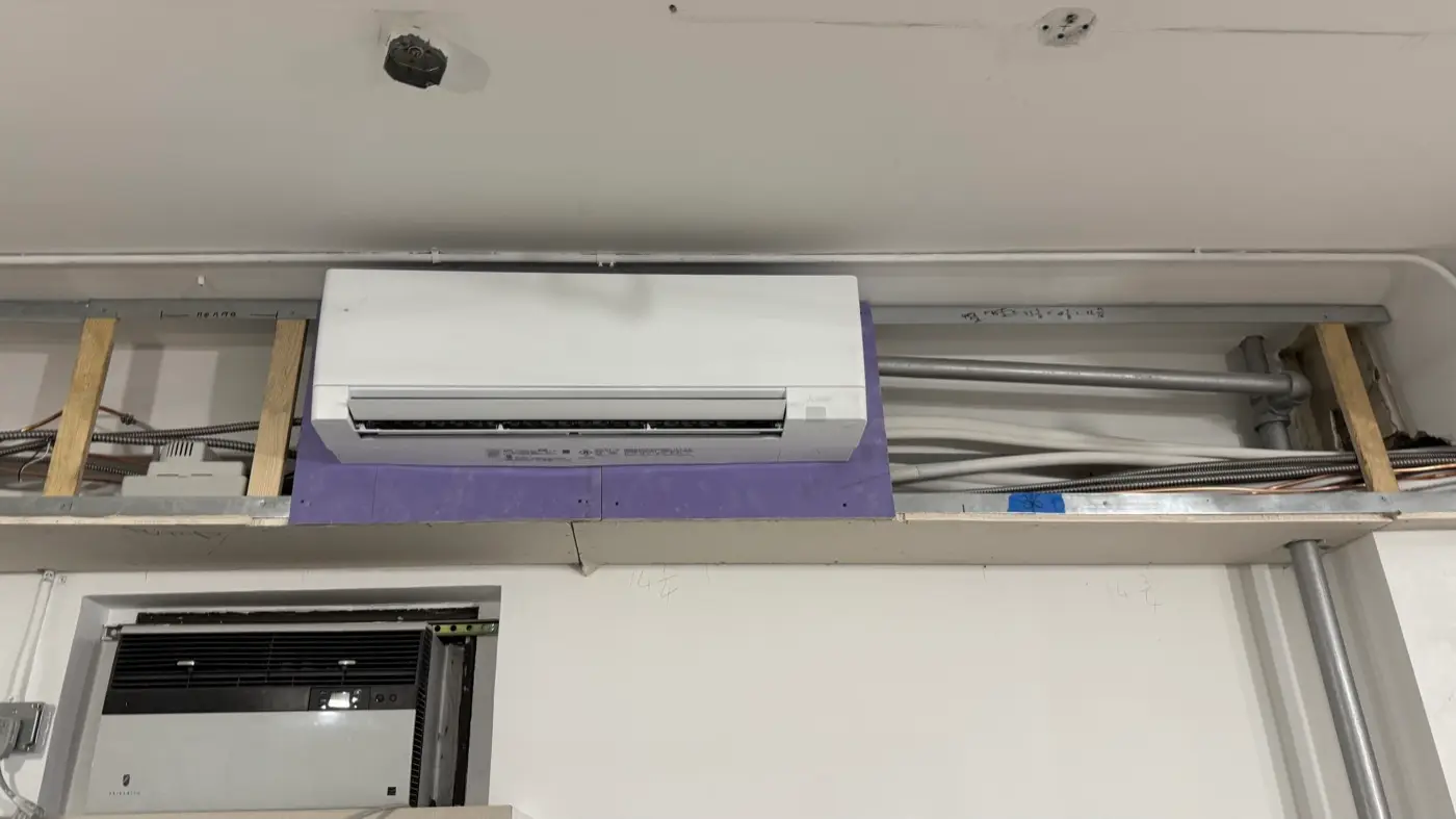 New Mitsubishi wall unit installed to replace an old through-wall air conditioner