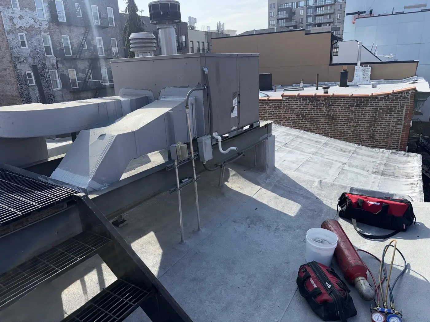 Rooftop air handler and ductwork serviced on a New York building