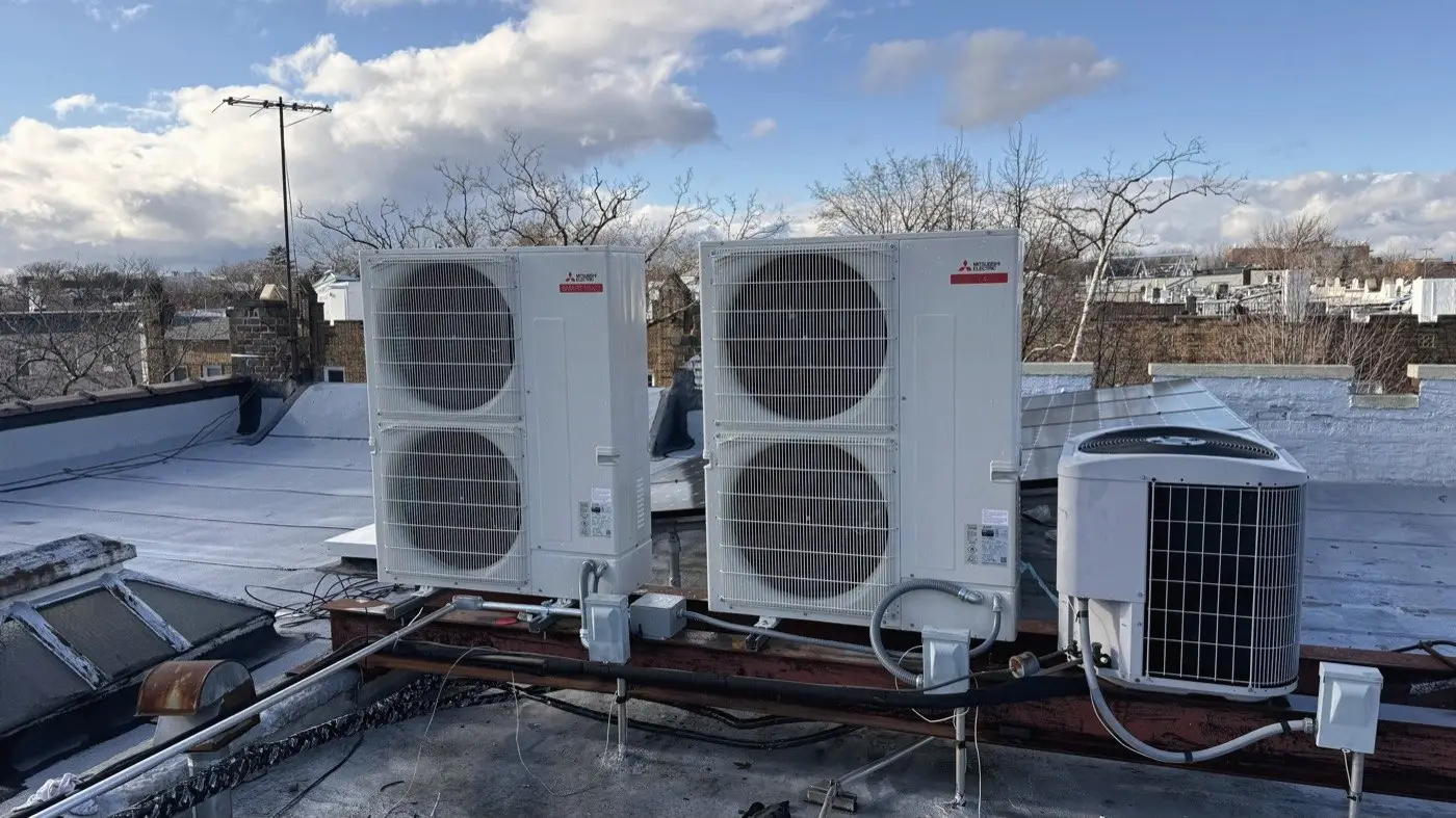 Rooftop condenser units under a clear sky